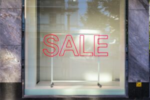 A window displaying a bright sale sign, inviting customers to explore the promotional offers inside.