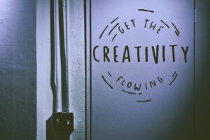 An photograph of a wall with the words "Get the creativity flowing" painted on it.