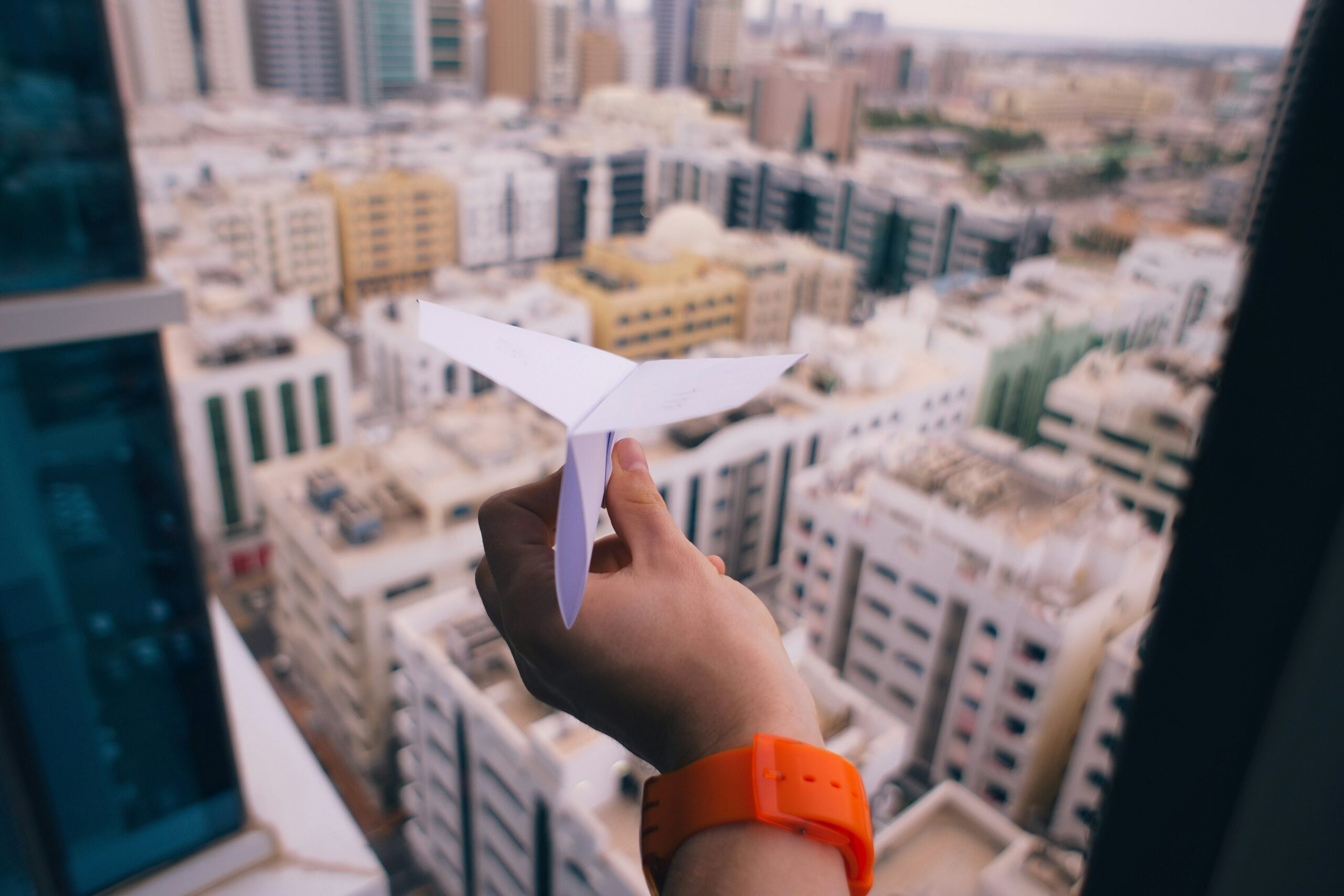 A image of a paper aeroplane being thrown out the window