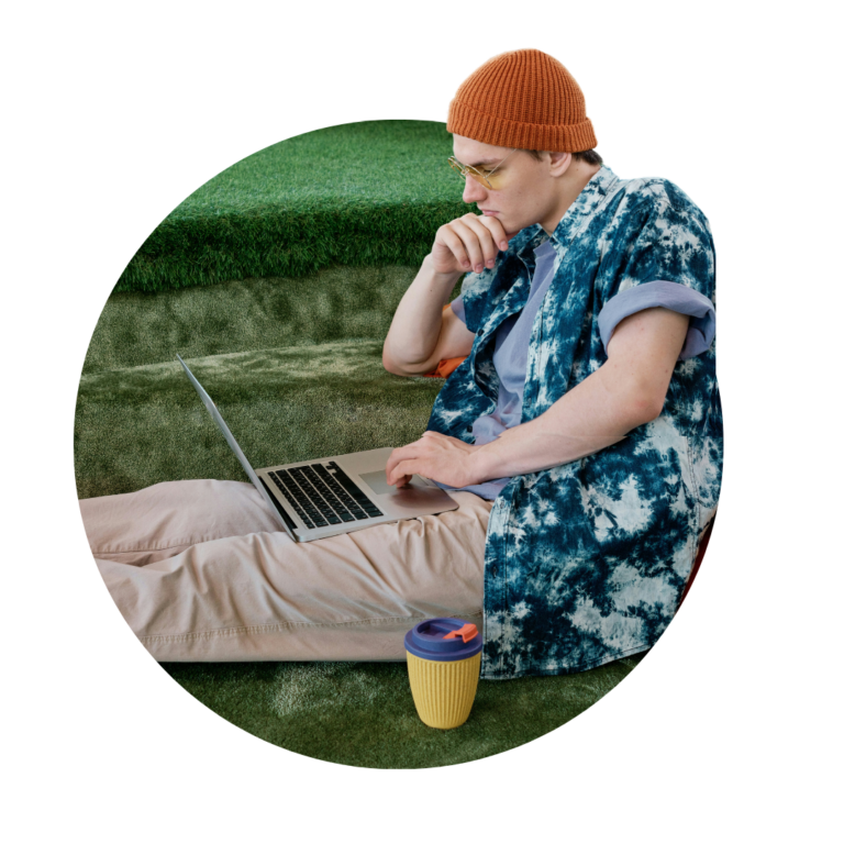 Editorial Guidelines. A person sat on the floor looking at their computer